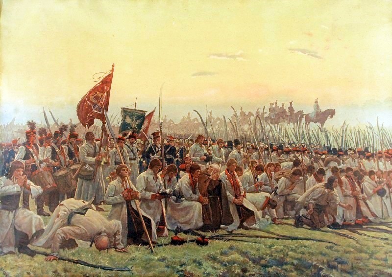 Chłopi mądlący się przed bitwa pod Racławicami na obrazie Józefa Chełmońskiego (domena publiczna).