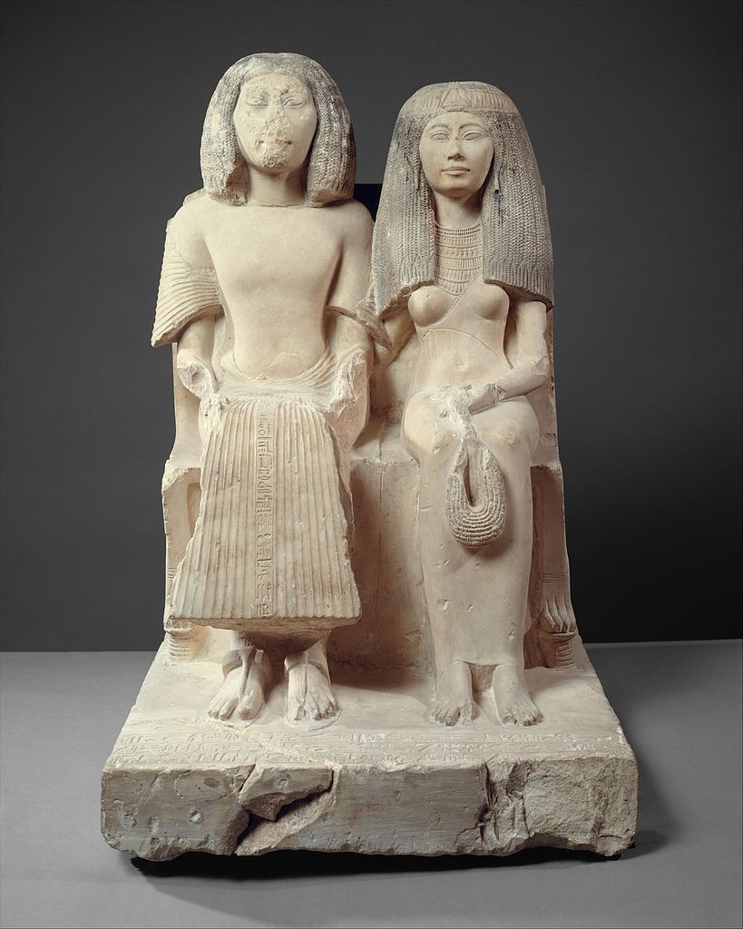 Starożytna egipska statuetka przedstawiająca Yuny'ego i jego żonę Renenutet (domena publiczna).